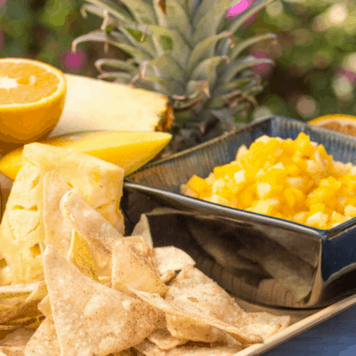 Summer means fresh fruit. And what better way to give your summer picnic a fun fruit twist than to make mango salsa with tropical fruit and homemade cinnamon chips? This mango salsa recipe is a dessert meets dip that is a favorite treat - especially when paired with homemade cinnamon tortilla chips. This isn’t a typical salsa in the sense that there are no savory or spicy notes to it (like cilantro or onion). It’s more like a fruit salad in an easy-to-scoop format. The result: a sweet snack that's not too sweet.