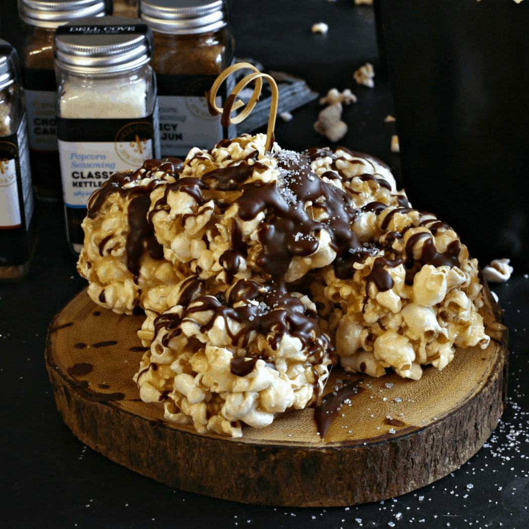 The Sparkly Chocolate Popcorn Balls were the result of our collaboration with Anita at the Hungry Couple blog. She whipped up an awards-show season dessert, namely these chocolate popcorn balls that sparkle and you gotta love other ways to use our metallic silver rim sugar! This sweet treat is a definite must for your movie night fun or binge-watching TV sessions. We’re making a batch of these to enjoy while watching the red carpet. One key warning: Making popcorn balls as a popcorn treat can be a very sticky process. It’s also a hands-on kind of kitchen project. So be sure to make these before you put on your fancy dress! We also suggest using Dell Cove® extra large Mushroom popcorn kernels for this recipe, which pop fat and round - making it perfect for making popcorn balls. We like to make these sparkly chocolate popcorn balls when we were hosting an Oscar nigh. It's always a fun evening to watch the Academy Awards and see who's walking the Red Carpet with who and of course seeing those fashions. Who's wearing who? It's quite a long show and treats are definitely in order for the evening. And they're always a hit! Everyone seems to love popcorn, and it is the movies that the show is celebrating, after all! Also, here's a bit of popcorn trivia for your movie night fun: While popcorn is typically seen as a snack food today, popcorn used to be enjoyed as a popular breakfast food. Food historians have traced the popcorn-as-a-breakfast-food (kind of like us eating puffed rice as cereal) trend back to the late nineteenth and early twentieth centuries. In fact, long before the Kellogg family was making corn flakes, some family members started their days with popcorn ground with milk or cream - and called popcorn “an excellent food.” We couldn’t agree more!