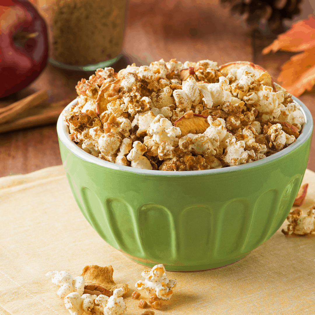 What’s better than apple pie? Apple pie popcorn! This easy apple pie popcorn is a yummy treat or snack, and fun to make. This recipe is our must-make for our family every Pi Day, too. And the brown sugar, ground cinnamon and chunks of popcorn pairs so well with chunks of dried apple. It gets baked for a few minutes and comes out all warm and crunchy. It’s a snack and dessert and a meal, all in one. Pi Day is March 14th – aka 3.14, the first three digits of pi. NASA calls pi the “Swiss Army knife of numbers”. But, no matter how big or small, the ratio of a circle’s circumference (the distance around it) to its diameter (the distance across it) is always equal to pi. David and I made this recipe for our family’s Sunday movie night tradition, where we are pairing popcorn and cocktails with our favorite films. So, here is our Pi Day movie snack and drink pairing: MOVIE: Hidden Figures (2016). The inspiring true story of three brilliant African-American women who worked at NASA in the 1950s and ’60s as “human computers” — and helped launch the manned spaceflight program. Starring Taraji P. Henson, Octavia Spencer and Janelle Monáe.